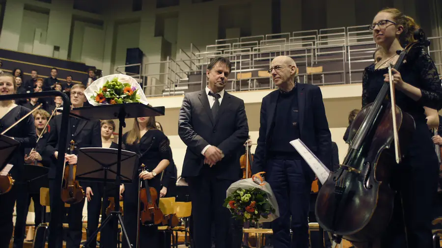 Michel Tilkin and Luc Van Hove on stage with the student orchestra